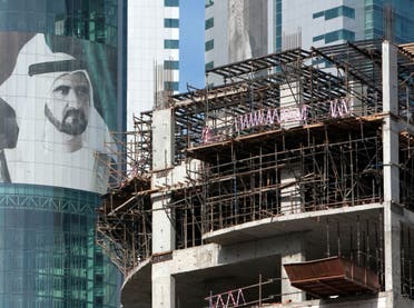 A picture of Sheikh Mohammed bin Rashid Al Maktoum, Vice President and Prime Minister of UAE and ruler of Dubai, is seen near construction sites in Dubai's Marina area, November 28, 2009. (Reuters)