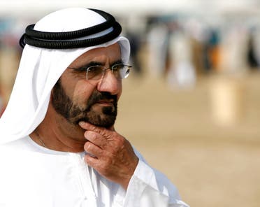 The ruler of Dubai, Sheikh Mohammed Bin Rashid Al Maktoum, walks toward the United Arab Emirates stable during a veterinary check at the equestrian endurance competition at the 15th Asian Games in the desert outside Doha December 14, 2006. (Reuters)