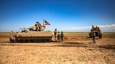 US Bradley Fighting Vehicles (BFV) patrol the countryside of the Kurdish-majority city of Qamishli in Syria's northeastern Hasakeh province, on April 20, 2022. (AFP)