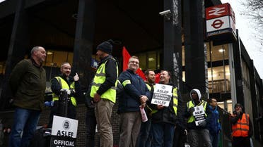 Rail workers that are members of the ASLEF union stand at a picket line outside Euston station while on strike, in London, Britain, January 5, 2023. (Reuters)