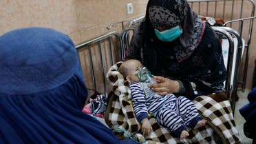 An Afghan woman with her child is seen in a hospital following an increase in the number of pneumonia cases in Kabul. (Reuters)
