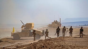 Fighters of the Syrian Democratic Forces (SDF) gather near a US Bradley Fighting Vehicle (BFV) during a joint military exercise with forces of the US-led “Combined Joint Task Force-Operation Inherent Resolve” coalition against ISIS in the countryside of the town of al-Malikiya (Derik in Kurdish) in Syria’s northeastern Hasakah province on September 7, 2022. (AFP)