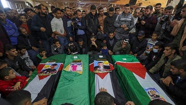 Mourners gather around the coffins of four Palestinian migrants who died off the Tunisian coast, during their funeral at a mosque in Rafah in the southern Gaza Strip on December 18, 2022. (AFP)