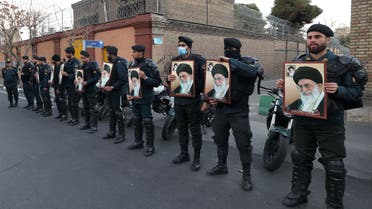 TOPSHOT - Policemen gather with images of Iran's supreme leader Ayatollah Ali Khamenei during a protest against defamatory cartoons depicting him published by French satirical weekly Charlie Hebdo, outside the French embassy in Iran's capital Tehran on January 8, 2023. (AFP)