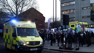 An ambulance on emergency call drives past ambulance workers' strike, amid a dispute with the government over pay, outside NHS London Ambulance Service in London, Britain on December 21, 2022. (Reuters)