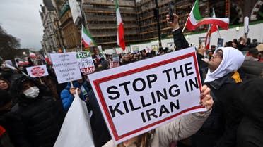 Protesters hold placards at a march in central London on January 8, 2023 against the Iranian regime. (AFP)