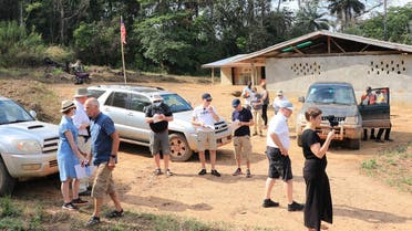 Judges from Finland arrive to the northern Liberian village of Kortuhum where they start a tour to collect testimonies as part of a first-of-a-kind trial of a warlord accused of committing atrocities during the country's civil war on February 18, 2021. (AFP)