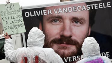 Protesters hold a placard reading ‘The priority is the right of living for Olivier’ during a solidarity demonstration with Belgian aid worker Olivier Vandecasteele in Brussels on December 25, 2022. (AFP)