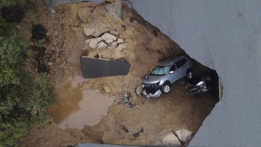 Several people had to be rescued after two vehicles fell into a sinkhole in Chatsworth, California, U.S., January 10, 2023. REUTERS/David Swanson