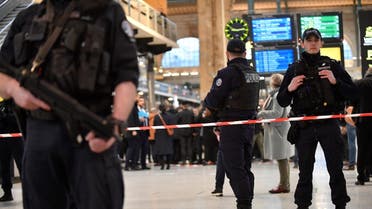 French police stand guard in a cordoned off area at Paris’ Gare du Nord train station, after several people were lightly wounded by a man wielding a knife on January 11, 2023. (AFP)