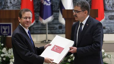 Turkey’s ambassador to Israel Sakir Ozkan Torunlar (R), presents his credentials to Israeli President Isaac Herzog, in Jerusalem, on January 11, 2023. (AFP)