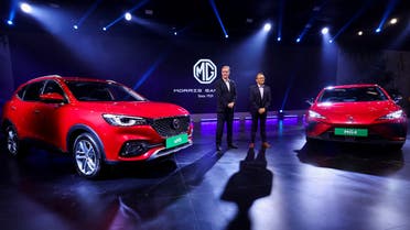 President and Managing Director of MG Motor India Private Limited Rajeev Chaba and Chief Commercial Officer MG Motor India Gaurav Gupta pose with MG EHS, Plug-in Hybrid and MG4 pure electric vehicle at the Auto Expo 2023 in Greater Noida, India, January 11, 2023. (Reuters)