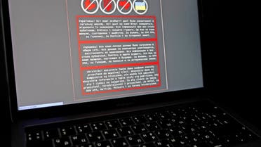 A laptop screen displays a warning message in Ukrainian, Russian and Polish, that appeared on the official website of the Ukrainian Foreign Ministry after a massive cyberattack, in this illustration taken January 14, 2022. (Reuters)