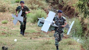 Lebanese Army soldiers carry parts of an Israeli drone in the Marjeyoun countryside, south Lebanon September 20, 2014. The Lebanese Army found the MK drone that fell in the Marjeyoun countryside near the Lebanese-Israeli border, the National News Agency (NNA) reported. The Israel Defence Forces confirmed that the unmanned aerial vehicle was from Israel, according to Israeli media. REUTERS/Karamallha Daher (LEBANON - Tags: POLITICS MILITARY TPX IMAGES OF THE DAY)