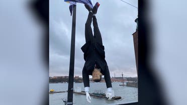 A puppet of Turkish President Tayyip Erdogan is hung by its feet during a demonstration in Stockholm, Sweden, January 12, 2023, in this image obtained from social media. (Twitter@realrojkom/via Reuters)