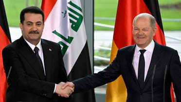German Chancellor Olaf Scholz (R) and Iraq’s Prime Minister Mohammed Shia al-Sudani shake hands at the end of a joint press conference following talks at the Chancellery in Berlin on January 13, 2023. (AFP)
