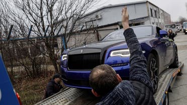 Romanian officials transport the cars seized from Andrew Tate's compound to a storage location in Pipera, Ilfov, Romania, January 14, 2023. (Inquam Photos/Octav Ganea via Reuters)