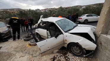 Onlookers surround a bullet-riddled car in which two Palestinians were reportedly killed by Israeli troops in Jaba near the West Bank town of Jenin, on January 14, 2023. (AFP)