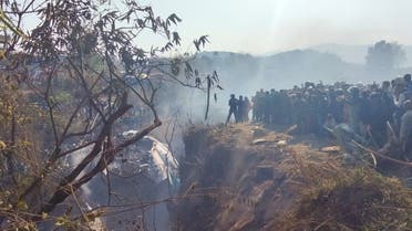 Crowds gather at the crash site of an aircraft carrying 72 people in Pokhara in western Nepal January 15, 2023. (Reuters)