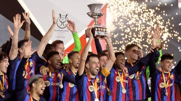  General view as FC Barcelona's Sergio Busquets lifts the trophy as he celebrates with teammates after winning the Spanish Super Cup. (Reuters)