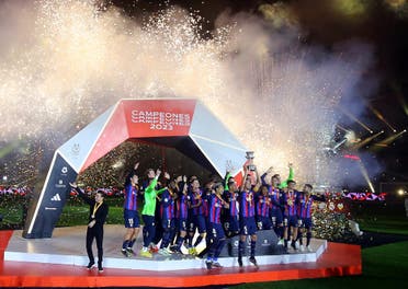  General view as FC Barcelona's Sergio Busquets lifts the trophy as he celebrates with teammates after winning the Spanish Super Cup. (Reuters)