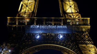 A photo shows the wods Stop executions in Iran displayed on the Eiffel Tower in Paris in support of the Iranian people, in the wake of the death of young Iranian woman Masha Amini who died in the country's morality police custody, in Paris, on January 16, 2023. (AFP)