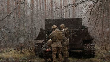 Soldiers with the 80th Separate Air Assault Brigade use their phones next to an APC at the front line on Orthodox Christmas, during a ceasefire announced by Russia over the Orthodox Christmas period, from the frontline region of Kreminna, Ukraine, January 6, 2023. REUTERS/Clodagh Kilcoyne