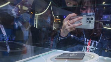 A visitor takes photos on processor Yitian 710 developed by Alibaba at the Apsara Conference, a cloud computing and artificial intelligence (AI) conference, in Hangzhou, in China's eastern Zhejiang province on October 19, 2021. (AFP)