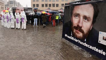 Protesters hold photos of Belgian aid worker Olivier Vandecasteele during a solidarity demonstration in Brussels on December 25, 2022. Brussels officials said on December 21, 2022, that Iran had imposed 28-year jail term on Belgian aid worker Olivier Vandecasteele, stirring an already bitter debate over a stalled prisoner exchange treaty. Vandecasteele was arrested in February, 2022, and is reportedly being held in Tehran's notorious Evin prison, in conditions that Belgian justice minister Vincent Van Quickenborne has described as inhumane. (Photo by François WALSCHAERTS / AFP)