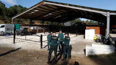 Spanish civil guards stand outside an illegal underground tobacco factory during a police raid in Monda, in southern Spain, on February 20, 2020. (Reuters)