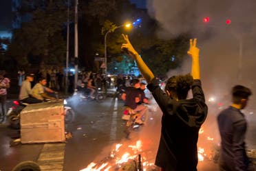 A file picture obtained by AFP outside Iran shows a demonstrator raising his arms and makes the victory sign during a protest for Mahsa Amini, a woman who reportedly died after being arrested by the Islamic republic's morality police, in Tehran on September 19, 2022. (AFP)