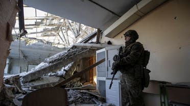 A Ukrainian serviceman is seen in a destroyed building of a school at a frontline, amid Russia's attack on Ukraine, in Donetsk region, Ukraine, on January 7, 2023. (Reuters)