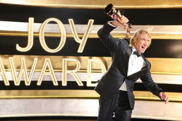 American filmmaker and producer Michael Bay holds up his award at the Joy Awards in Riyadh, Saudi Arabia. (Supplied)