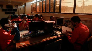 Volunteers of the Edhi Foundation, a non-profit social welfare programme, work at a communication and control room during a country-wide power breakdown in Karachi, Pakistan, on January 23, 2023. (Reuters)