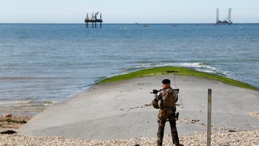 A French serviceman stands guard in front of the sea during a ceremony marking 78 years since Allied forces landed in Normandy during World War II, in Bernieres-sur-Mer, on June 6, 2022. (AFP)