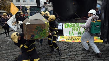 Demonstrators disguised as bees and bees keeper perform in Brussels on November 19, 2021, as they take part in a protest against the Common Agricultural Policy in Europe. (AFP)