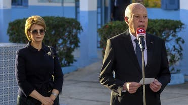 A handout picture provided by the press service of Tunisian presidency shows President Kais Saied speaking after voting with his wife Ichraf Chebil at a polling station in the Ennasr district near Tunis on December 17, 2022, during the parliamentary election. (Tunisian Presidency/AFP)