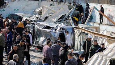 Palestinians inspect the damage following an Israeli raid in Jenin in the Israeli-occupied West Bank January 26, 2023. (Reuters)
