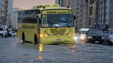 A school bus and other vehicle partially submerged as heavy rains batter parts of the UAE. (Twitter)
