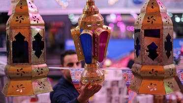 A man checks a traditional Ramadan lantern, called “fanous,” at a shop stall ahead of the Muslim holy month of Ramadan in Cairo, Egypt, on April 8, 2021. (Reuters)