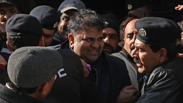 Police officials escort Pakistan's former information minister Fawad Chaudhry (C) as they leave the court after a hearing in Islamabad on January 27, 2023. (AFP)
