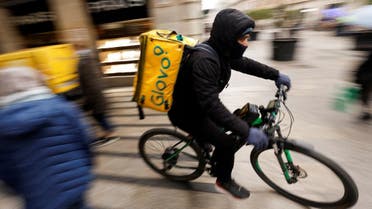 A Glovo delivery rider passes by a pedestrian area in Barcelona, Spain, January 24, 2023. (Reuters)