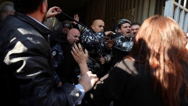 Demonstrators confront with police as they attempt to break in the Justice Palace, during a protest against steps taken this week to hamstring a probe into the 2020 port blast, in Beirut, January 26, 2023. (Reuters)