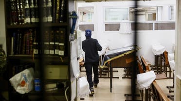 Security personnel scans a synagogue following a shooting attack in Neve Yaacov which lies on occupied land that Israel annexed to Jerusalem after the 1967 waron  January 27, 2023. (Reuters)