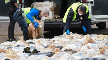 Spanish policemen check packs of cocaine in the port of Vigo, on April 28, 2020 after seizing the vessel MV Karar carrying 4000 kgs of cocaine. (AFP)