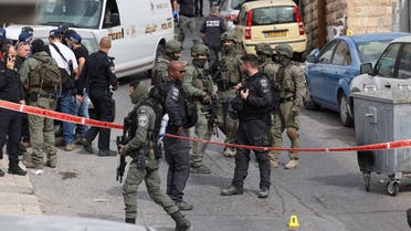 Israeli security forces and emergency service personnel gather at a cordoned-off area in Jerusalem’s predominantly Arab neighbourhood of Silwan, where an assailant reportedly shot and wounded two people, on January 28, 2023. (AFP)
