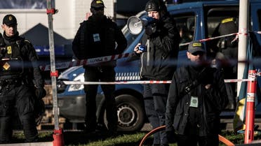 Danish police officers surround far-right politician Rasmus Paludan ahead of burning by him a copy of the Quran in front of the Turkish embassy in Copenhagen, Denmark, on January 27, 2023. (Reuters)