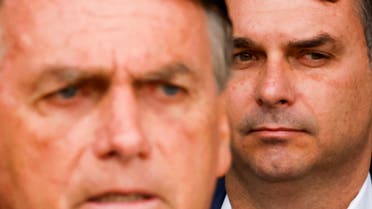 Senator Flavio Bolsonaro looks on next to Brazil's then-President and candidate for re-election Jair Bolsonaro during a news conference at the Alvorada Palace in Brasilia, Brazil October 4, 2022. (Reuters)