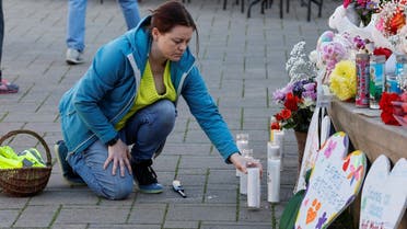 Kati McHugh lights candles for the seven shooting victims at a memorial for shooting victims, in Half Moon Bay, California, US, on January 25, 2023. (Reuters)