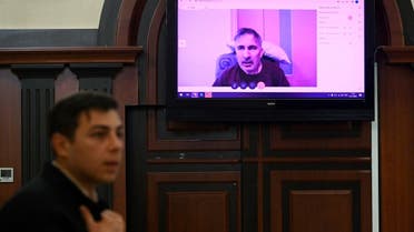Georgia's ex-President Mikheil Saakashvili appears on a screen via a video link from a clinic during a court hearing in Tbilisi on December 22, 2022, that will consider deferring his sentence of abuse of office over poor health. (AFP)